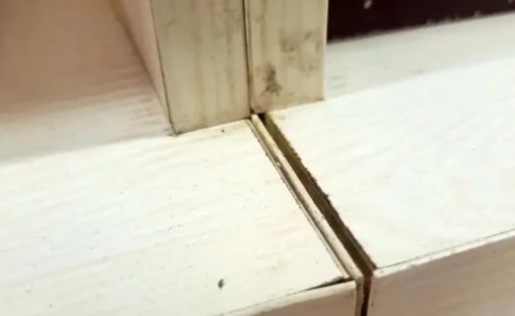 Cabinet panels meeting at a rough, mis-aligned joint