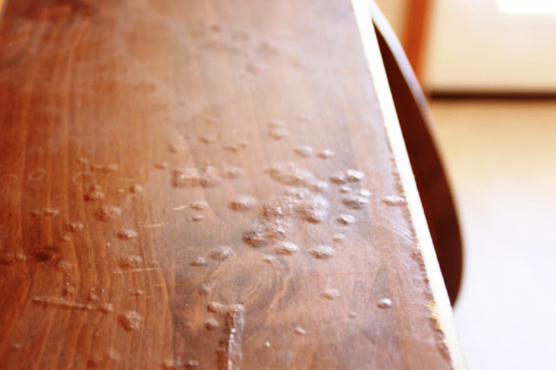 Wood surface blistered and swollen from prolonged moisture exposure